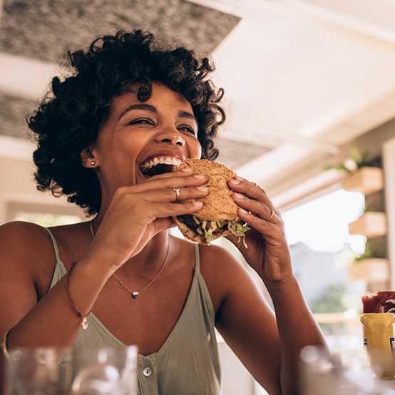 Woman biting into a hamburger