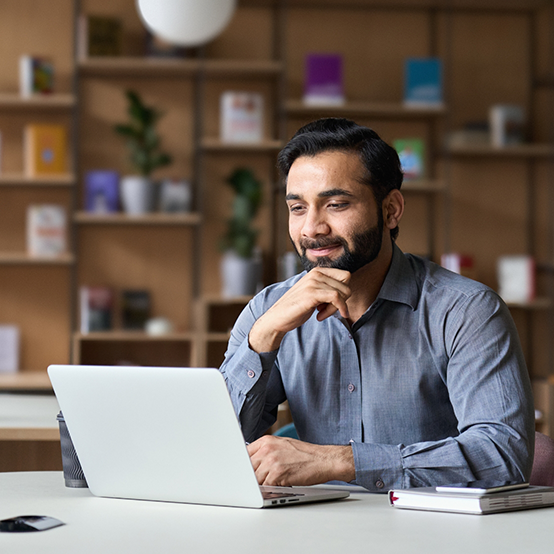 Man sitting at table and using laptop