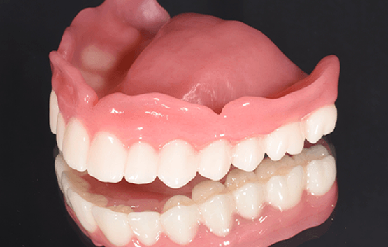 Full denture against black background